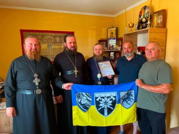 Епископ УПЦ сфотографировался с изображением боевой свиньи и псом из языческой мифологии