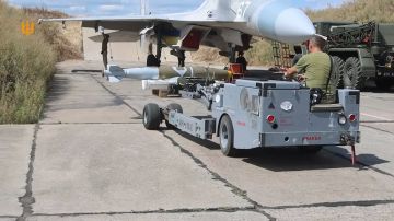 Американский аэродромный погрузчик MHU-83 везет бомбу JDAM к истребителю-бомбардировщику Су-27 ВС Украины